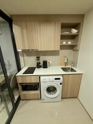 a kitchen with a washing machine and a sink at The Base Rise in Phuket Town