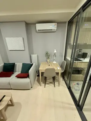 a living room with a couch and a table at The Base Rise in Phuket Town
