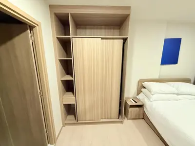 a small bedroom with a bed and a closet at The Base Rise in Phuket Town
