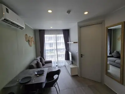 a living room with a table and chairs and a living room at Seabreeze Suite 1-Bed T3-637 in Phuket Town