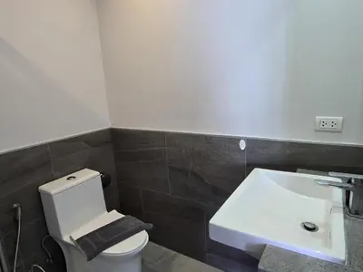 a bathroom with a white toilet and a sink at Seabreeze Suite 1-Bed T3-637 in Phuket Town