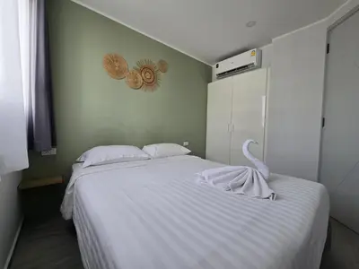 a bedroom with a white bed with a swan on it at Seabreeze Suite 1-Bed T3-637 in Phuket Town