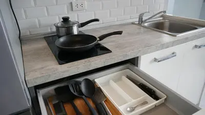 a frying pan sitting on top of a stove in a kitchen at Coastal Comfort 2 Bed T2-617 in Phuket Town