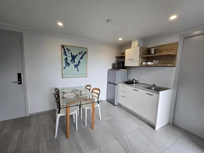 a kitchen with a table and chairs in a kitchen at Coastal Comfort 2 Bed T2-617 in Phuket Town