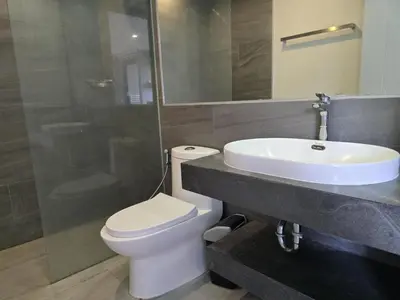a bathroom with a white toilet and a sink at Coastal Comfort 2 Bed T2-617 in Phuket Town