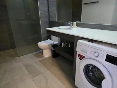 a bathroom with a washing machine and a sink at Sea Side Haven 1 Bed T2-621 in Phuket Town