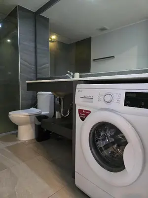 a white washing machine in a bathroom with a toilet at Sea Side Haven 1 Bed T2-621 in Phuket Town