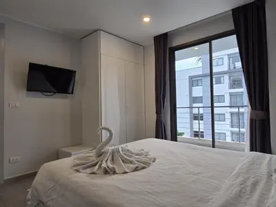 a bedroom with a swan on a bed with a window at Sea Side Haven 1 Bed T2-621 in Phuket Town