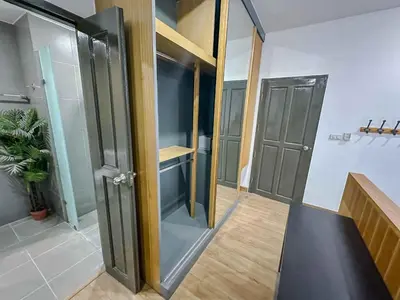 a walk in closet with glass doors in a room at Beachside Bliss 2- Bed HM612 in Phuket Town