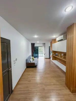 an empty living room with a couch and a kitchen at Beachside Bliss 2- Bed HM612 in Phuket Town