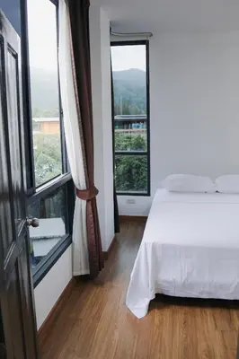 a bedroom with a bed and a large window at Beachside Bliss 2- Bed HM612 in Phuket Town