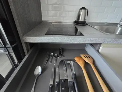 a kitchen drawer with knives and utensils in it at Lagoon Loft Studio T3-627 in Chalong
