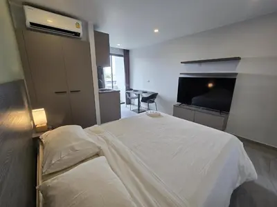 a bedroom with a bed and a flat screen tv at Palm Bay Studio T3 -532 in Phuket Town
