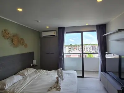 a bedroom with a bed and a large window at Urban Tide Studio T3 -626 in Chalong