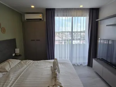 a bedroom with a bed and a large window at Urban Tide Studio T3 -626 in Chalong
