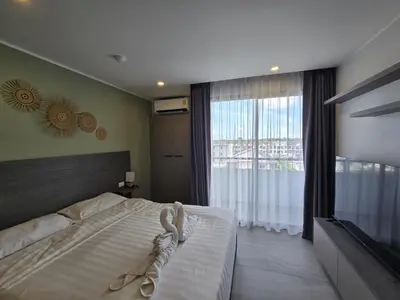 a bedroom with a bed and a large window at Urban Tide Studio T3 -626 in Chalong