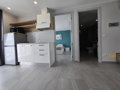 a kitchen with white cabinets and a white refrigerator at Skyline Serenity 1Bed T2-721 in Phuket Town