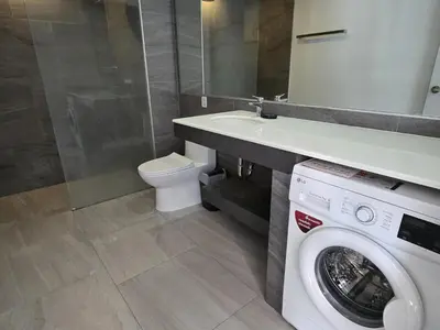 a bathroom with a washing machine and a sink at Skyline Serenity 1Bed T2-721 in Phuket Town
