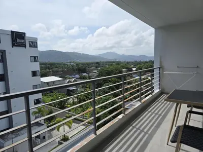 a balcony with a view of a city at Skyline Serenity 1Bed T2-721 in Phuket Town