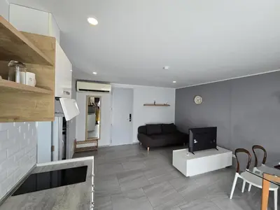 a living room with a couch and a television at Skyline Serenity 1Bed T2-721 in Phuket Town