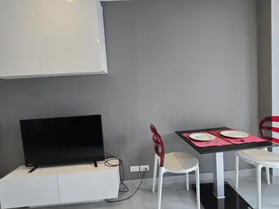 a kitchen with a table and a tv and a table and chairs at 1 BR Condo in good location NV402 in Phuket Town
