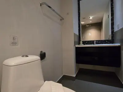 a bathroom with a toilet and a sink and a mirror at 1 BR Condo in good location NV402 in Phuket Town