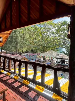 a view from a window of a bridge with people on the street at Bangalow Coconut corner in Ban Laem Sai