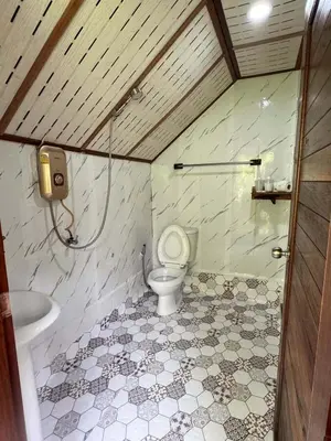 a bathroom with a toilet and a sink at Bangalow Coconut corner in Ban Laem Sai