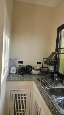 a kitchen with a counter top with a stove top at Tropical 1BR Bungalow in Rawai with Shared Pool in Nai Harn Beach