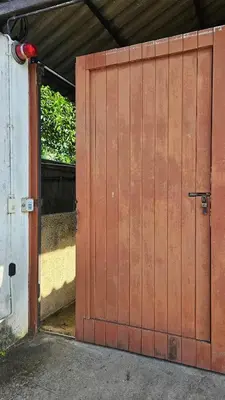 an open wooden door of a garage with a door at Tropical 1BR Bungalow in Rawai with Shared Pool in Nai Harn Beach