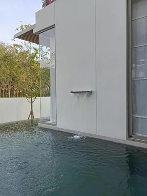 a pool of water next to a building with a fountain at Luxury Design 3 Bedroom Villa AB2 in Phuket Town