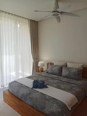 a bedroom with a large bed with a ceiling fan at Luxury Design 3 Bedroom Villa AB2 in Phuket Town