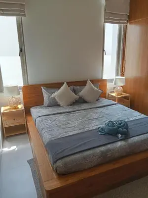 a bedroom with a large bed with a blue blanket at Luxury Design 3 Bedroom Villa AB2 in Phuket Town