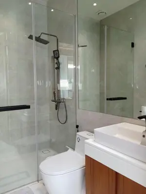 a bathroom with a shower and a toilet and a sink at Luxury Design 3 Bedroom Villa AB2 in Phuket Town