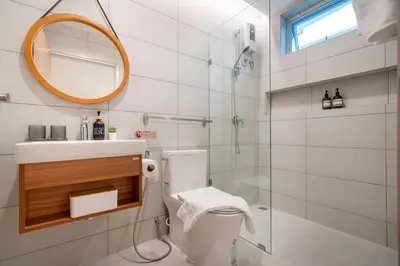 a bathroom with a toilet and a sink and a mirror at At Bangla Patong Pool Moon villa in Patong Beach