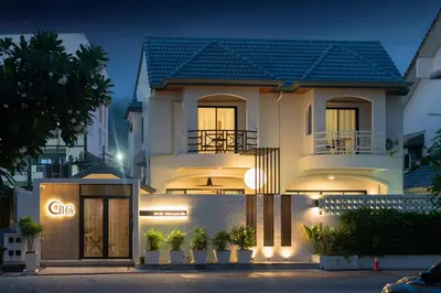 a white house with a cgs sign in front of it at At Bangla Patong Pool Moon villa in Patong Beach