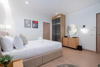 a bedroom with a large bed and a mirror at At Bangla Patong Pool Moon villa in Patong Beach