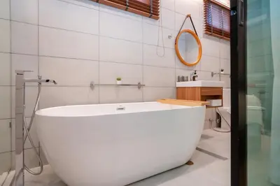 a white bath tub in a bathroom with a mirror at At Bangla Patong Pool Moon villa in Patong Beach