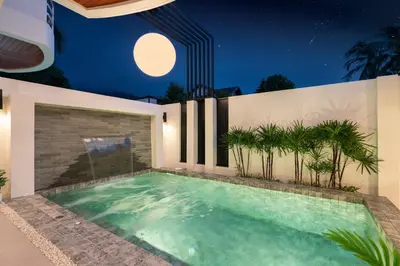 a swimming pool in a house at night with the moon overhead at At Bangla Patong Pool Moon villa in Patong Beach