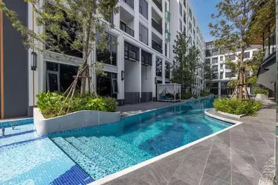 a swimming pool in front of a building at Bellevue by Villacarte in Laguna Phuket