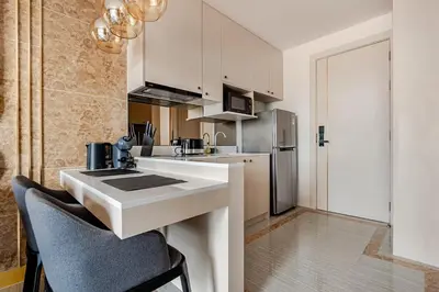 a kitchen with a sink and a refrigerator at Bellevue by Villacarte in Laguna Phuket