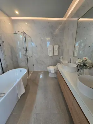a bathroom with two sinks and a tub and a shower at Bangtao Family 3 Bedroom Villa in Ban Pak Lak