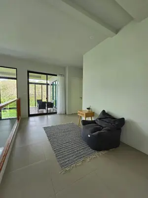 a living room with a couch and a rug at Bangtao Family 3 Bedroom Villa in Ban Pak Lak