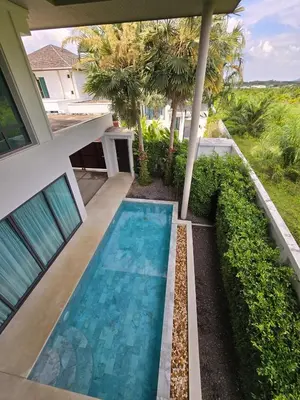 a swimming pool in the backyard of a house at Bangtao Family 3 Bedroom Villa in Ban Pak Lak