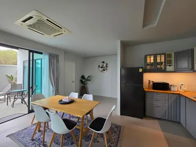 a kitchen and dining room with a table and chairs at Bangtao Family 3 Bedroom Villa in Ban Pak Lak