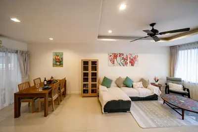 a living room with a couch and a table at Townhouse in the very center of Laguna, 600 m from Bang Tao in Phuket