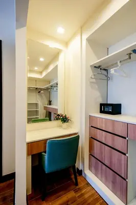 a room with a desk and a green chair at Townhouse in the very center of Laguna, 600 m from Bang Tao in Phuket