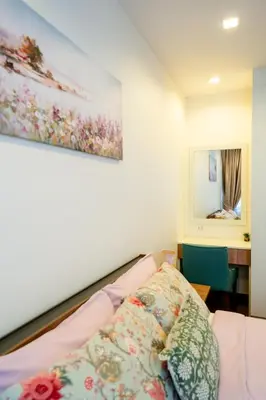 a bedroom with a bed and a painting on the wall at Townhouse in the very center of Laguna, 600 m from Bang Tao in Phuket