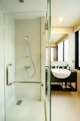 a bathroom with a glass shower and a sink at Townhouse in the very center of Laguna, 600 m from Bang Tao in Phuket