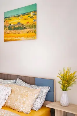 a bedroom with a bed and a painting on the wall at Townhouse in the very center of Laguna, 600 m from Bang Tao in Phuket